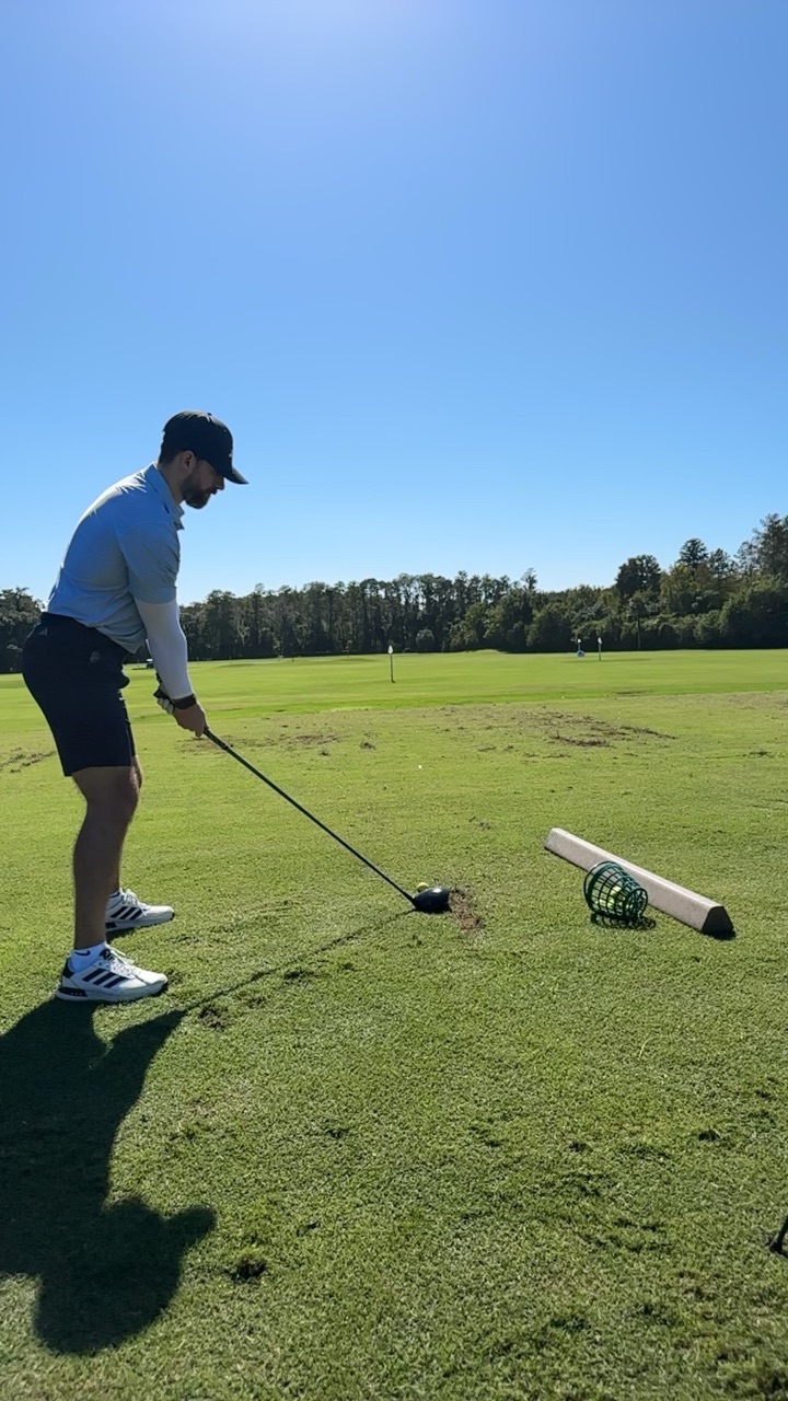 Chris at address with his driver, seen through the camera